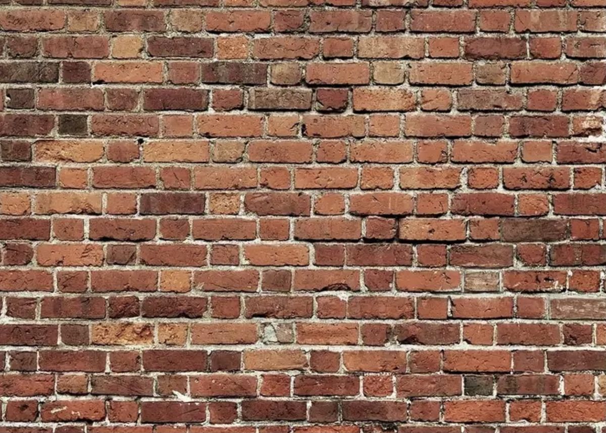 Weathered red brick wall with pale mortar joints